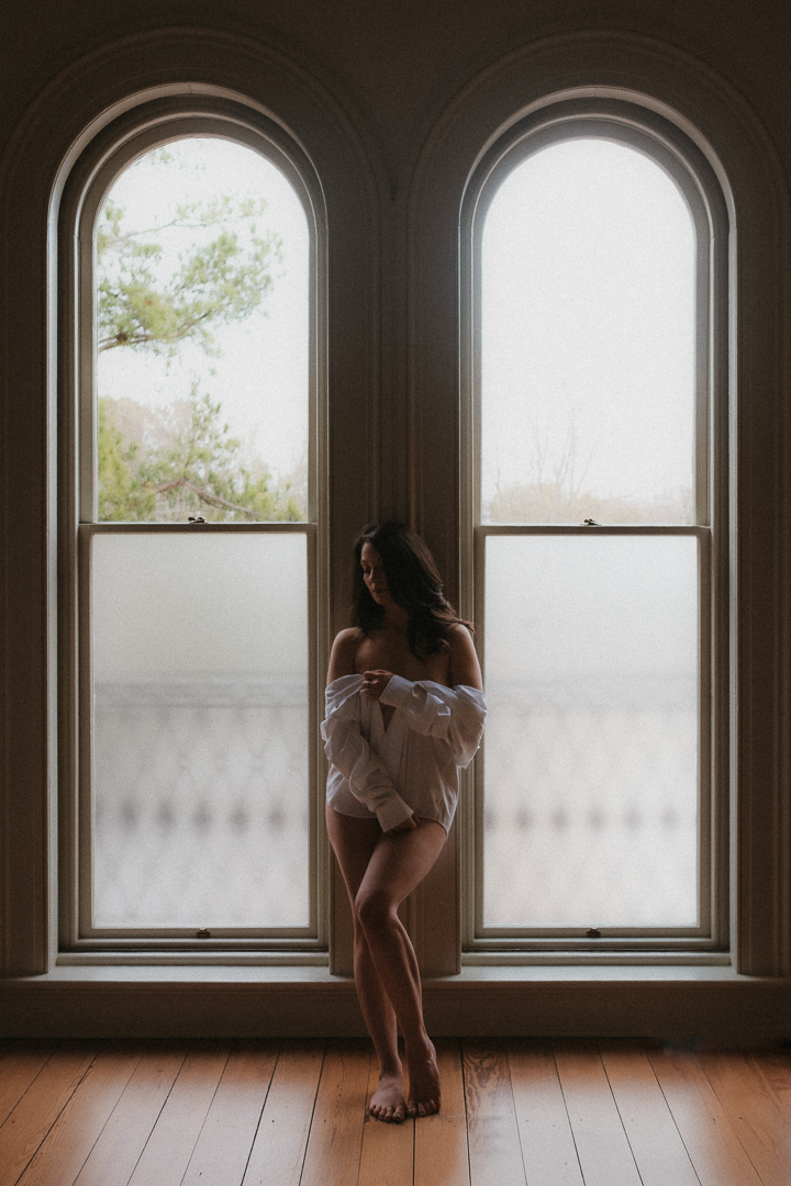 Heights House Honeymoon Suite Boudoir Photo Session Woman in front of double windows with man's dress shirt