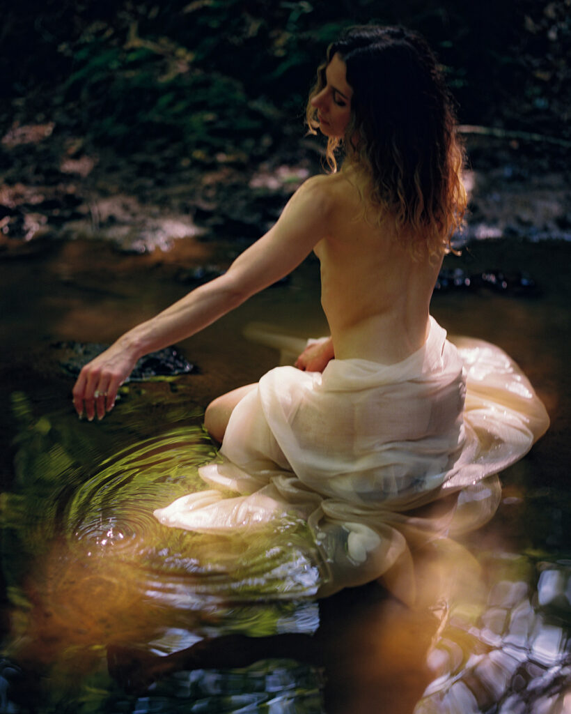 woman bathing in stream wrapped in silk in durham, NC