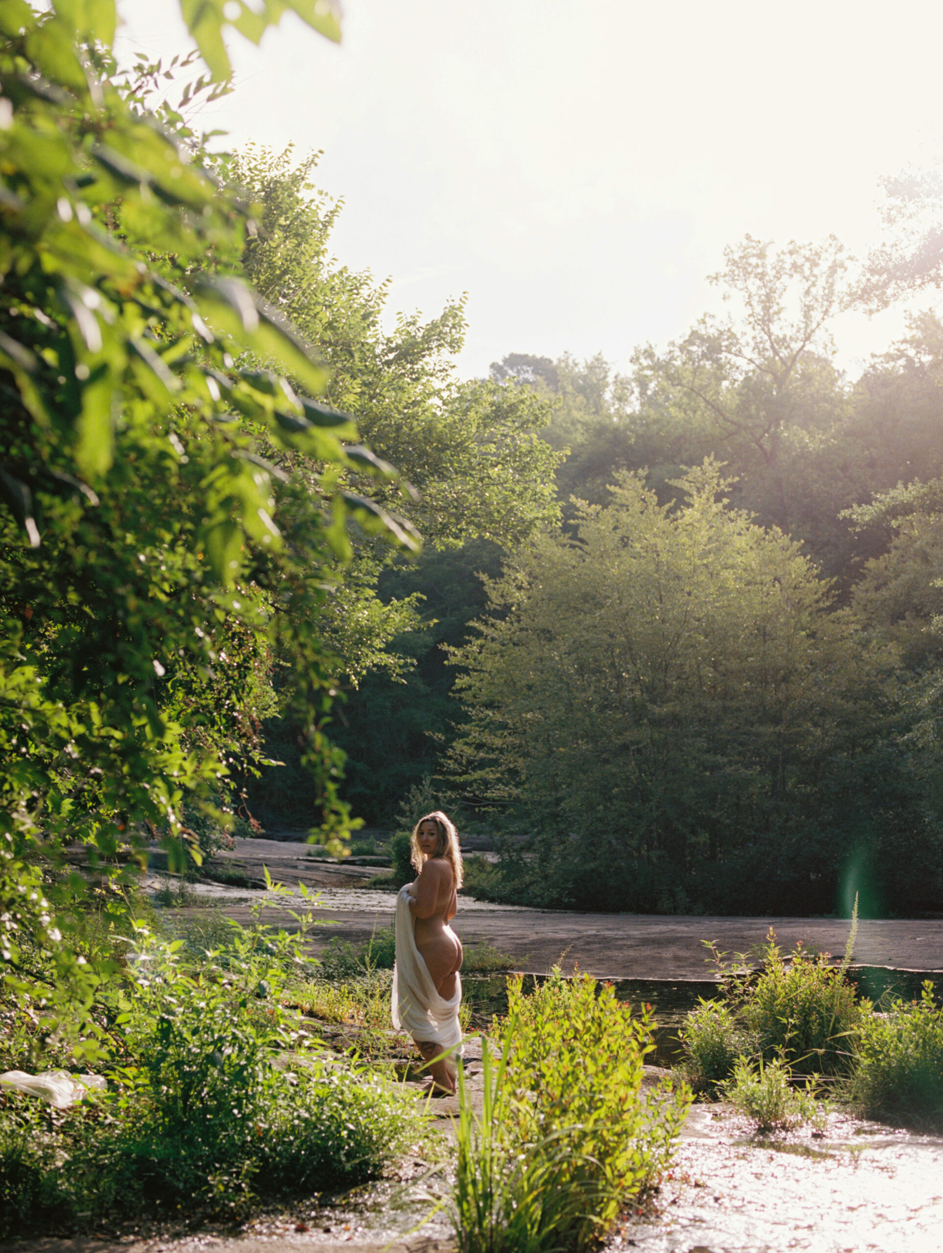 Goddess in the summer early morning sun standing surrounded by trees in Raleigh, NC
