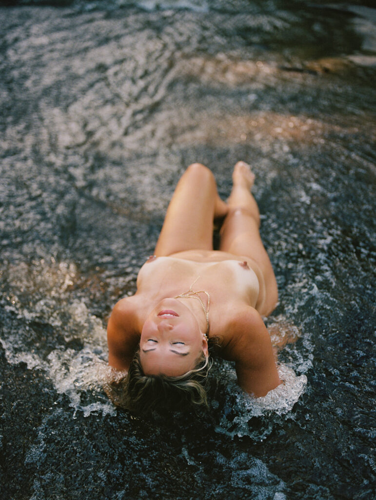 Woman wrapped in river water posing in stream at sunrise, outdoor fine art film photography by K Hammock Photography North Carolina