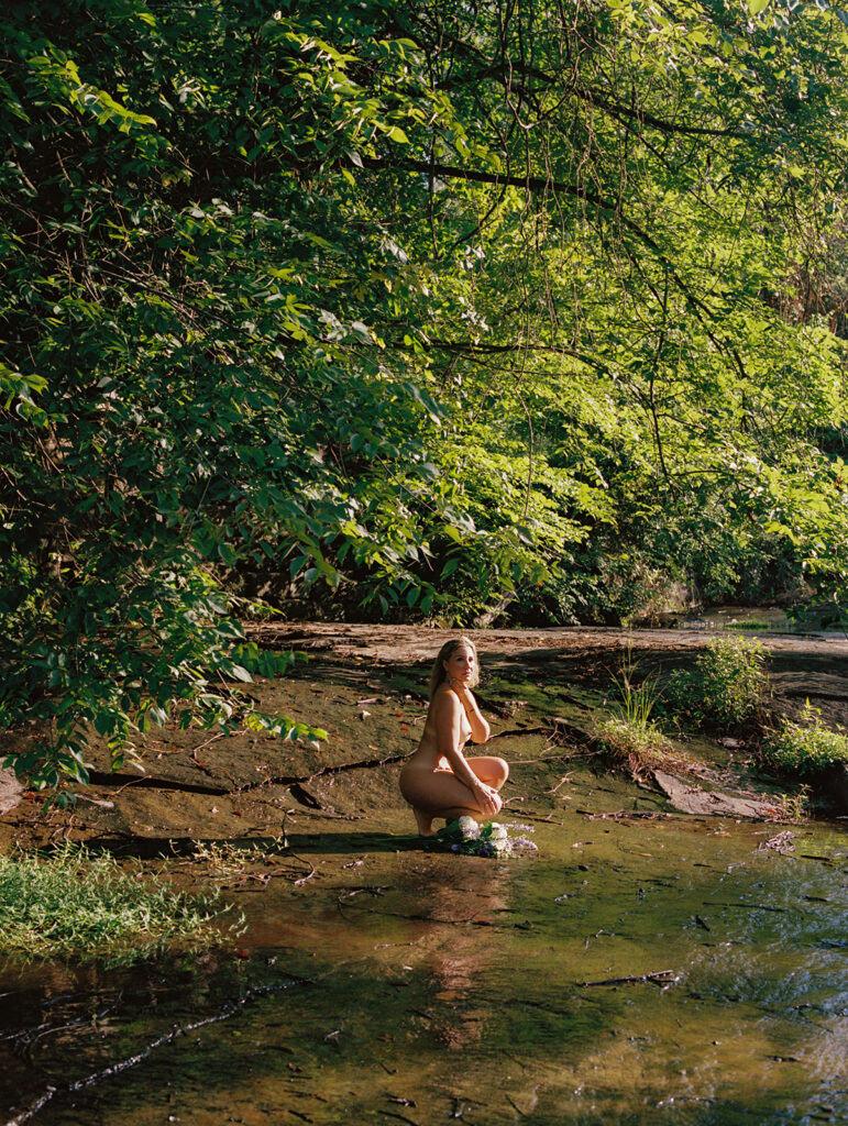 Woman wrapped in trees and looking towards her reflection at sunrise, outdoor fine art film photography by K Hammock Photography North Carolina